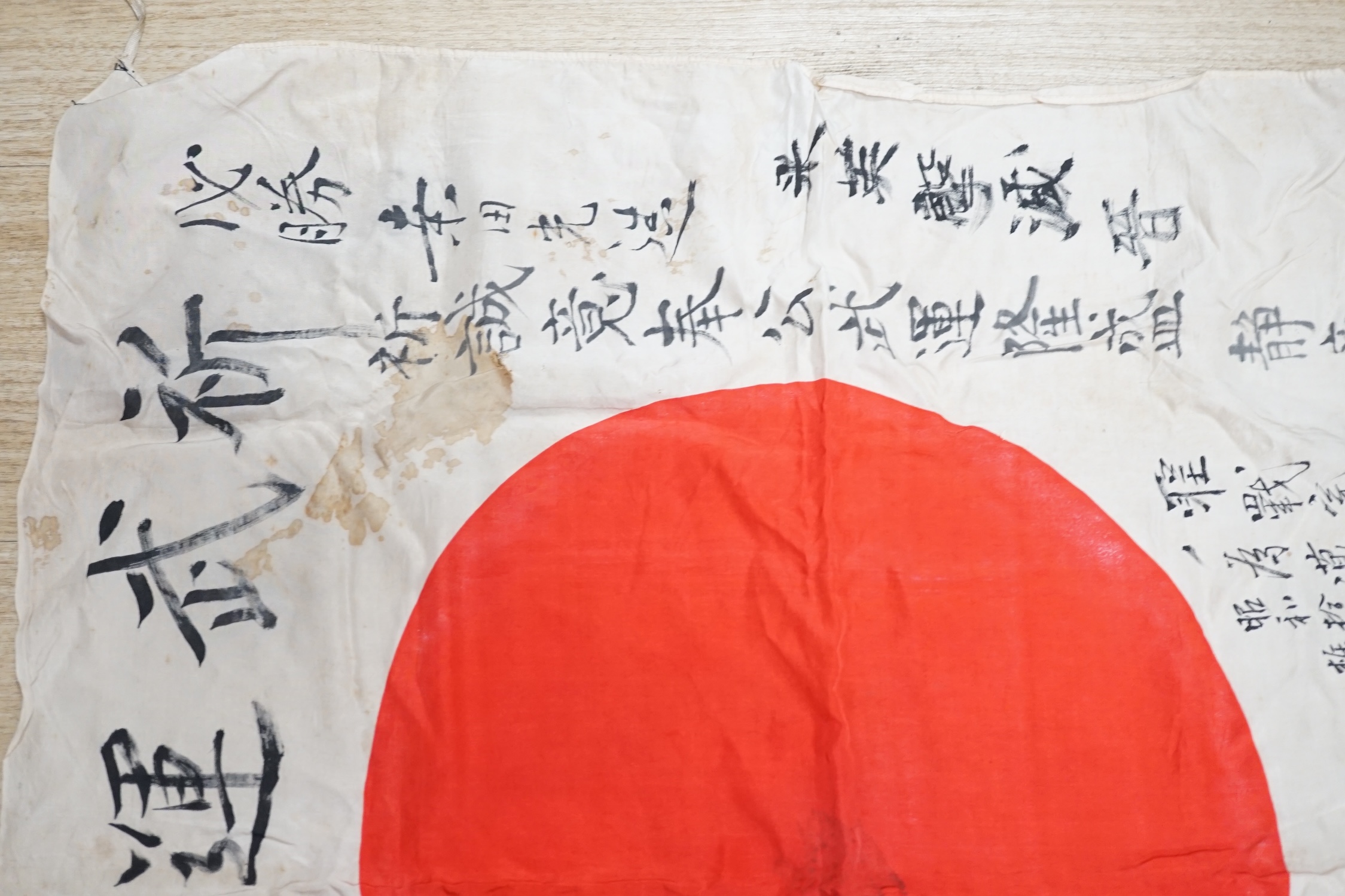 A WWII Japanese signed silk prayer flag, 83 x 73cm. Condition - fair, significant staining in some areas